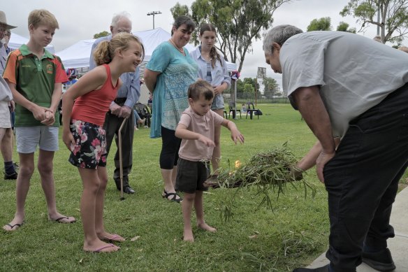 Elder Phil Sullivan conducts the smoking ceremony and Welcome to Country at local Australia Day celebrations in the NSW town of Bourke.