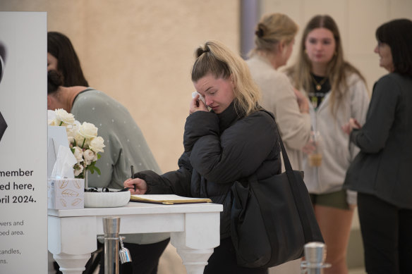 A shopper signs the condolence book set up to mourn the victims of last week’s Westfield Bondi Junction tragedy.