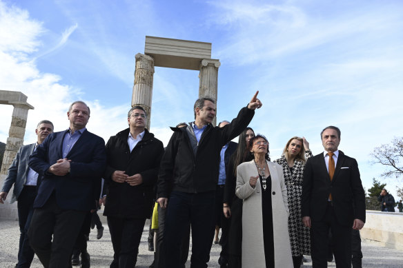 Greek Prime Minister Kyriakos Mitsotakis, centre, visits the Palace of Aigai which opens for visits from Sunday.