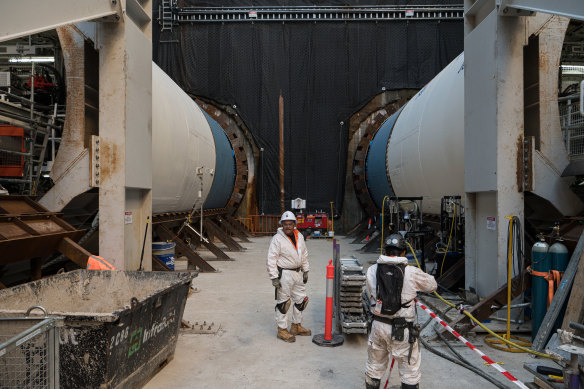 Workers in the huge hole dug at the Bays in Rozelle for a metro train station.