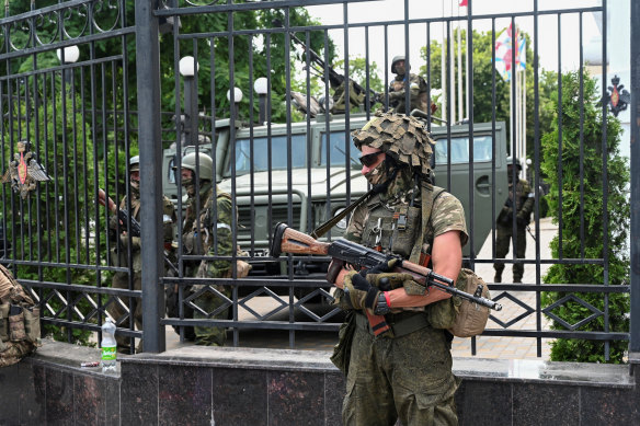 Fighters of Wagner private mercenary group stand guard outside the headquarters of the Southern Military District in the city of Rostov-on-Don on Saturday. 