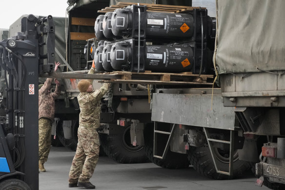 Ukrainian servicemen load Javelin anti-tank missiles onto military trucks. More are set to be delivered under the assistance package approved this week.