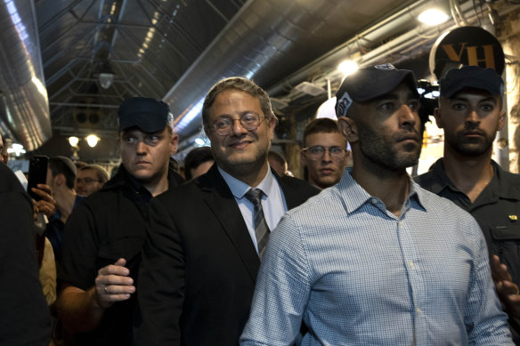 Far-right Israeli MP Itamar Ben-Gvir (centre) makes a campaign stop in west Jerusalem’s Mahane Yehuda market, days after brandishing a gun and urging police to shoot rioters in the city’s occupied east.