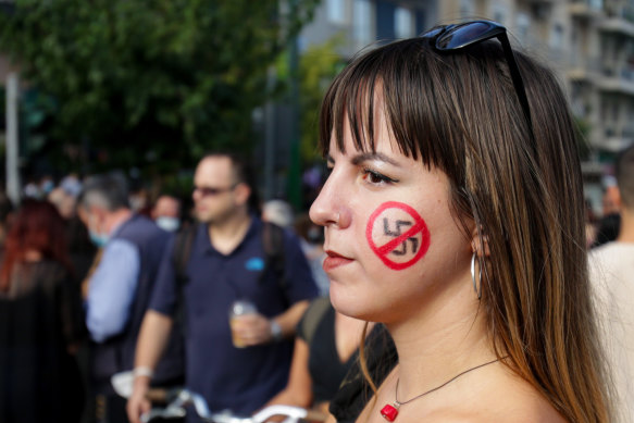 A woman sports an anti-fascist face marking during a protest outside the Golden Dawn trial in Athens, Greece.
