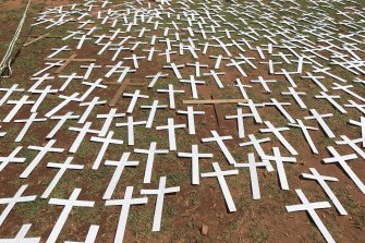 Protesters lay 'cross' symbols on the ground during a protest against farmer murders in South Africa.