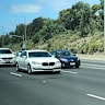 Prime Minister Scott Morrison rides in his armoured BMW 750iL, shadowed by his protective officers in their BMW X5, on his way to the Australian Open tennis.