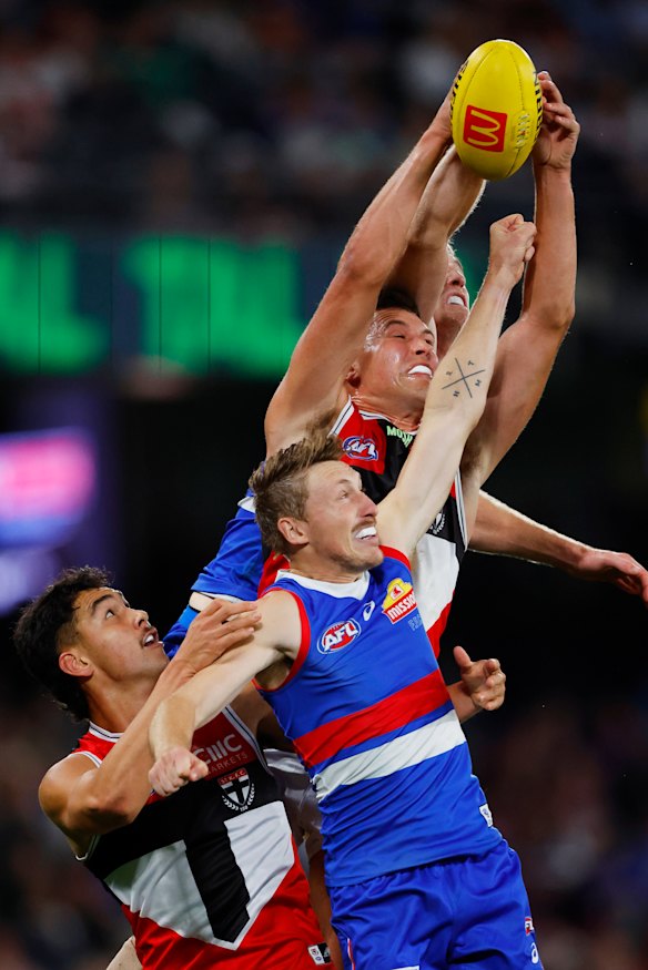St Kilda’s Mitch Owens outreaches  Bulldogs Bailey Dale (front) and Tim English while teammate Rowan Marshall 9bottom left) also competes for the ball.