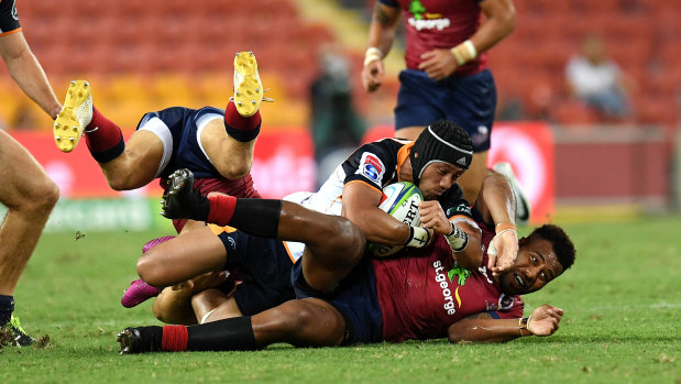 Christian Lealiifano of the Brumbies (top) is stopped by Samu Kerevi of the Reds.