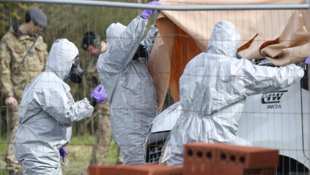 Soldiers wearing protective clothing cover  a tow truck in Hyde Road, Gillingham, Dorset, England as the investigation into the suspected nerve agent attack on Russian double agent Sergei Skripal continues.