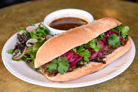 Perfect pub food: brisket torta with birria broth for dipping.