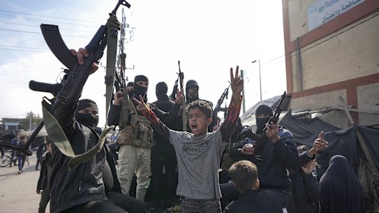 Members of the Izzedine al-Qassam Brigades, the armed wing of Hamas, celebrate the ceasefire in Deir al-Balah.