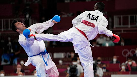 Sajad Ganjzadeh of Iran, left, is injured while competing against Tareg Hamedi of Saudi Arabia in their men’s kumite +75kg gold medal bout.