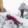 The ski season will finally begin on Tuesday after a cold front brought a large dumping of snow to Thredbo. Sam and Kristie Lau-Adams spent Sunday morning enjoying the  falls with their daughter Goldie and son Iggy.