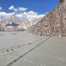 Hussaini Suspension Bridge, a precarious 193-metres-long rope bridge spanning the Hunza River that looks dangerous but is used daily by locals.