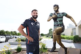 Bronzed Aussie: Alex Johnston with his statue at Maroubra.
