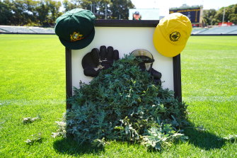 Rod Marsh’s Baggy Green cap and wicketkeeping gloves and sprigs of wattle.