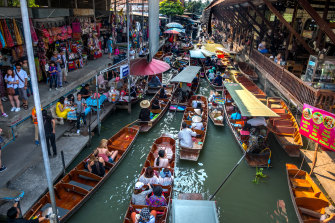 Boats, tourists and vendors pack into the Damnoen Saduak Floating Market near Bangkok, Thailand. 