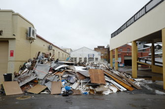 Debris sits piled up outside businesses affected by the recent floods in the main town on March 28 in Lismore.