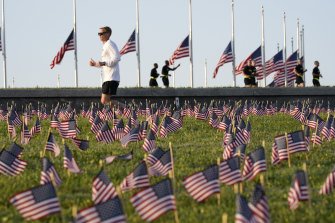 Thousands of flags have been planted in front of the Washington Monument in Washington to honour the 200,000 US lives lost so far in the pandemic.