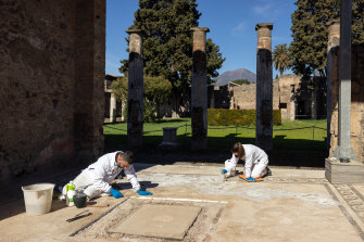 Restorers Aldo Guida, left, and Valentina Cifali at work on the mosaic floor of the House of the Faun at Pompeii.
