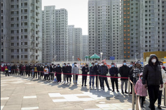 Residents line up for the coronavirus test during a mass testing in north China’s Tianjin municipality, on January 9, 2021. 