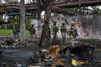 Russian troops walk in a destroyed part of the Illich Iron & Steel Works Metallurgical Plant in Mariupol on May 18.