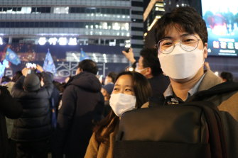 Hwang Jung-min, a 29-year-old researcher with her partner Shin Seon-hyeop at a Lee rally in March. 