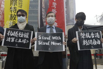 Protesters hold slogans reading “Protest Against Totalitarian Liquidation of Stand News” and ” Support Press Freedom in Hong Kong” in Taipei, Taiwan, on THursday.