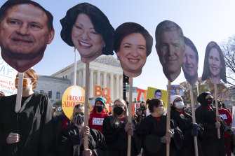 Abortion rights advocates holding cardboard cutouts of the Supreme Court Justices, demonstrate in front of the US Supreme Court, as it hears arguments in the case from Mississippi.