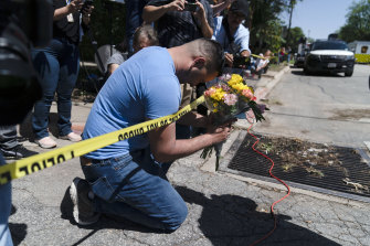 Joseph Avila prays while holding flowers honouring the victims killed in Tuesday’s shooting at Robb Elementary School in Uvalde, Texas.