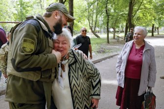 A serviceman of Donetsk People’s Republic militia embraces a local woman in Svitlodarsk, in territory under the government of the Russia-backed Donetsk People’s Republic, in eastern Ukraine,