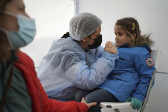 Suzanne, 5, is tested for COVID-19 in Albigny-sur-Saone, north of Lyon.