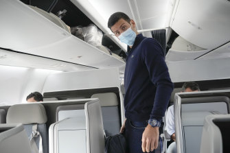 Novak Djokovic prepares to take his seat on a plane to Belgrade, in Dubai, United Arab Emirates, on Monday.
