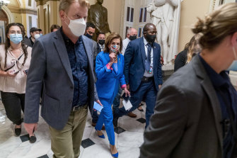 US House Speaker Nancy Pelosi, centre, is trying to convince her own party to vote for the infrastructure bill.