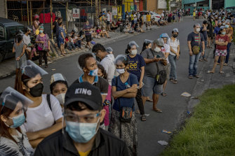 People queue hoping for a COVID vaccination in Manila.