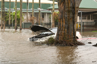 A car is inundated by floodwater in Lismore.