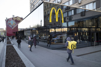 People walk past a McDonald’s restaurant in the main street in Moscow, in March, before they closed following sanctions due to the Russian invasion of Ukraine.