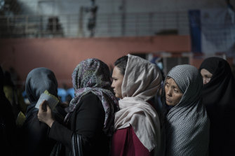 Women wait to receive cash at a money distribution organised by the World Food Program (WFP) in Kabul last week.