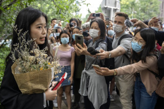 Zhou Xiaoxuan, a former intern at China’s state broadcaster CCTV, speaks outside a courthouse before attending a session in her court case against a television host she accuses of groping and forcibly kissing her.