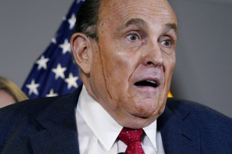 Hair dye runs down the face of Donald Trump’s personal lawyer Rudy Giuliani  during a press conference in November. 