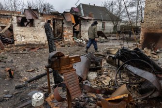 A man walks through the rubble of his and his neighbour’s homes on Friday in Andrivka, Ukraine.