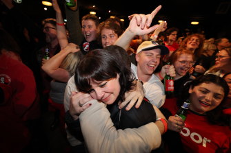 Embracing the moment: Labor supporters could tell where things were headed on Saturday night.
