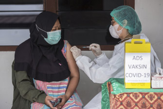 Nurse Novita Sirait gives a COVID-19 vaccine to a colleague at a community health centre in Medan, North Sumatra, Indonesia.