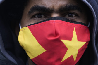 A protester wears a face mask in the colors of the Tigray regional flag as he attends a protest in Berlin, Germany in January.