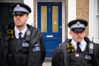 Police officers stand guard outside a home in the Kentish Town neighbourhood of London where suspect Ali Harbi Ali had recently lived. 