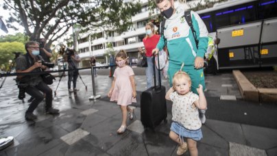 David Warner walks into the team hotel with his family.