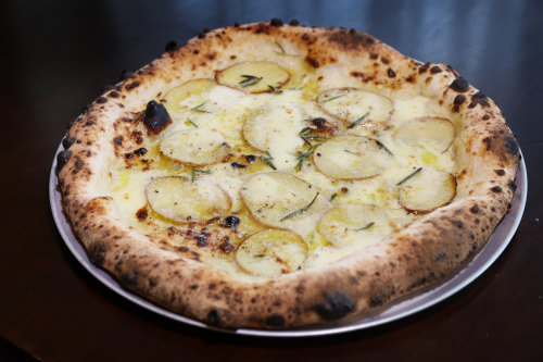 Potato pizza with potato, gorgonzola cream, fior di latte, rosemary and parmigiano.