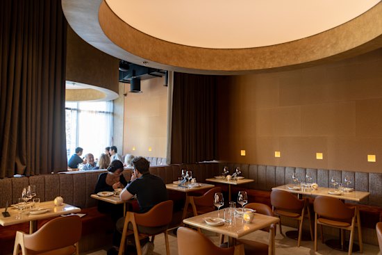 Moya & Co studio has designed an elegant dining room with a stunning cylindrical ceiling feature.