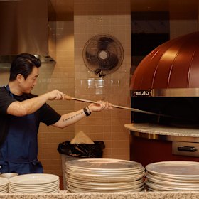 Head chef Sangsub Ha cooks the pizzas in a rotating Marana wood-fired oven.