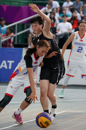 Mongolia’s Khulan Onolbaatar is checked by Okuyama Ririka of Japan during a 3x3 at the Asian Games in Indonesia in 2018.